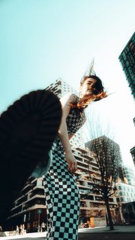 Energetic portrait of a woman with wind-swept hair in urban Utrecht.
