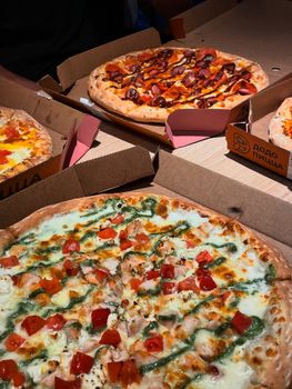 A variety of delicious pizzas with diverse toppings, perfect for sharing a meal.