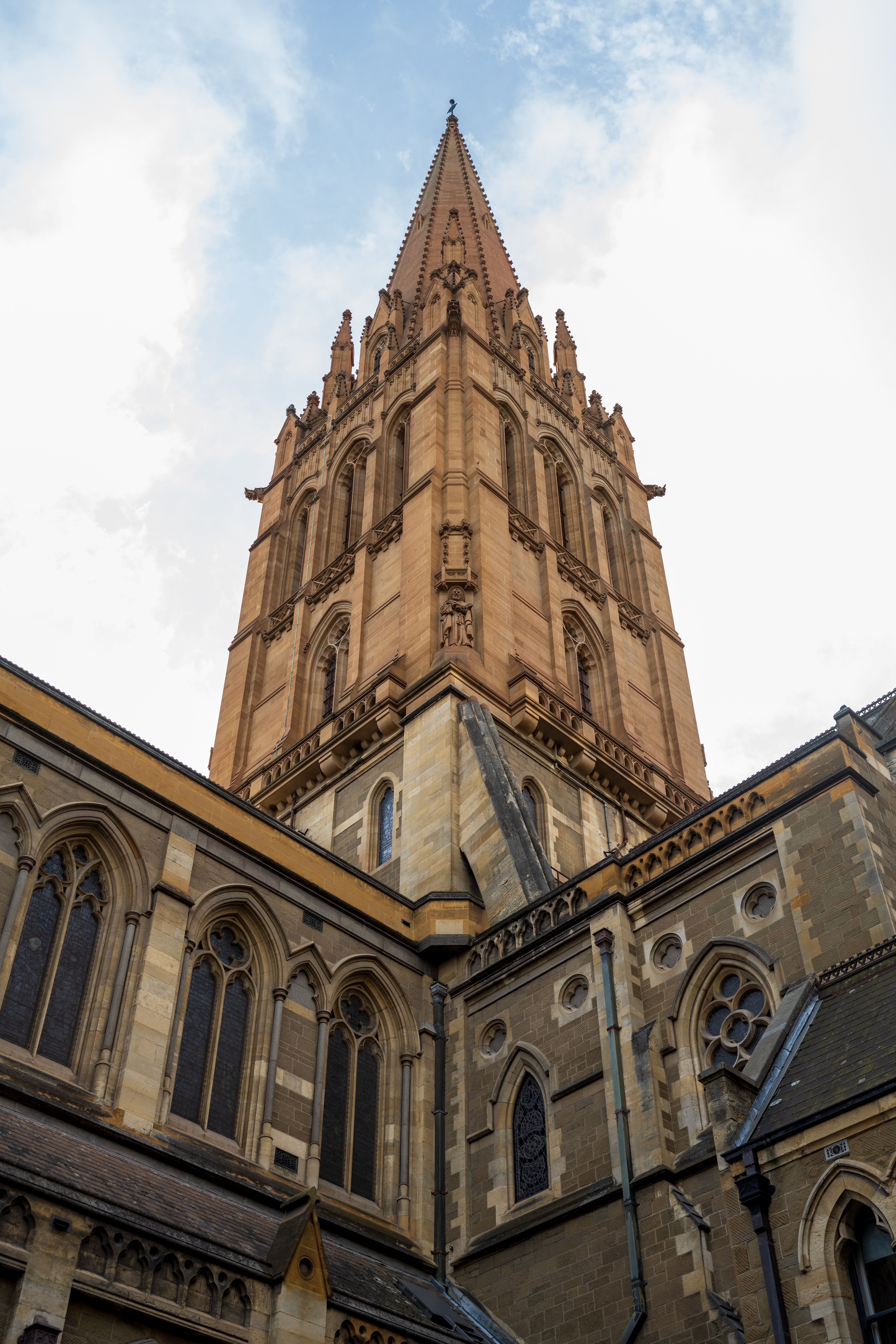 Stunning Gothic Cathedral Tower Against Blue Sky · Free Stock Photo