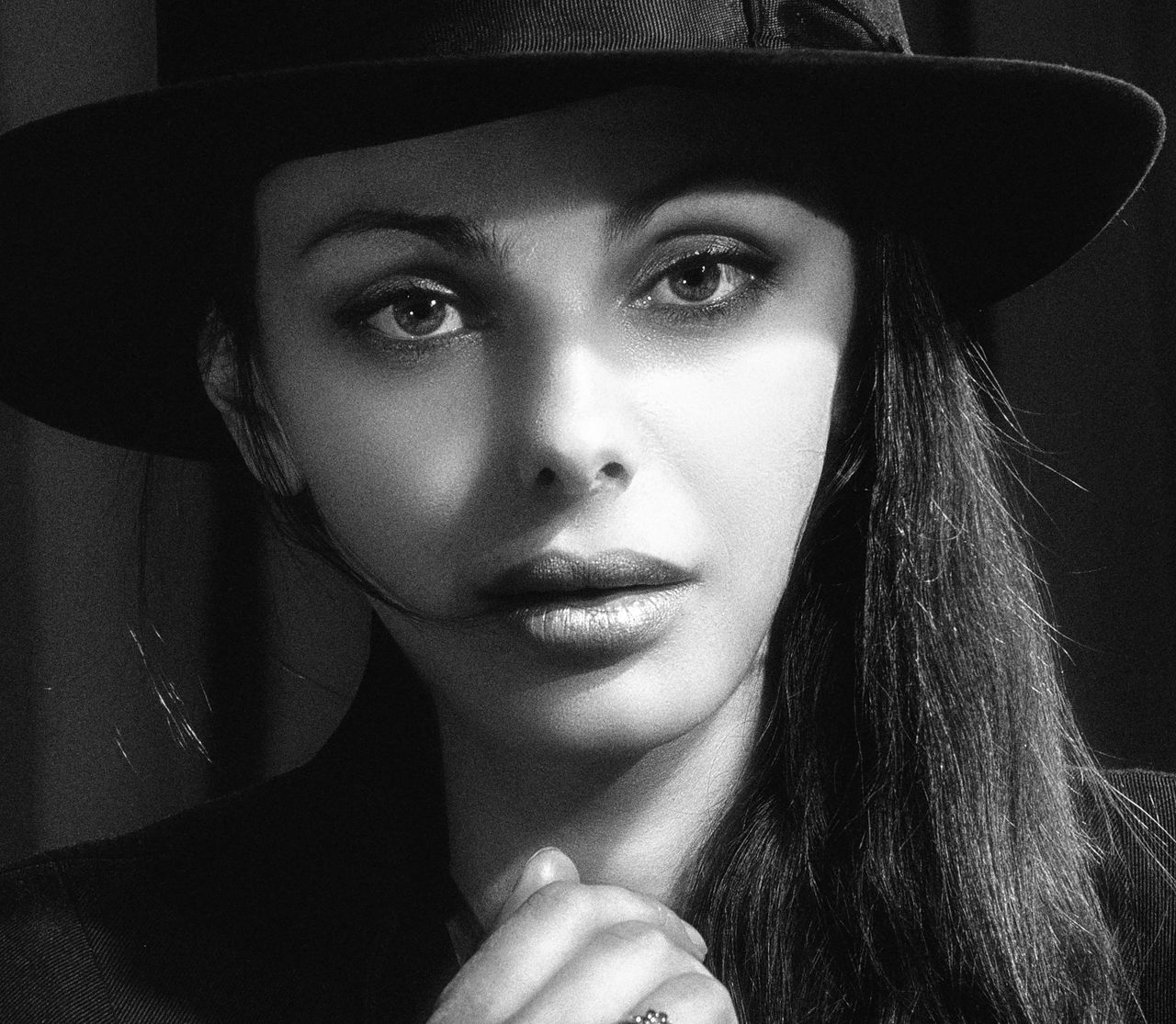 elegant black and white portrait of a woman wearing a hat