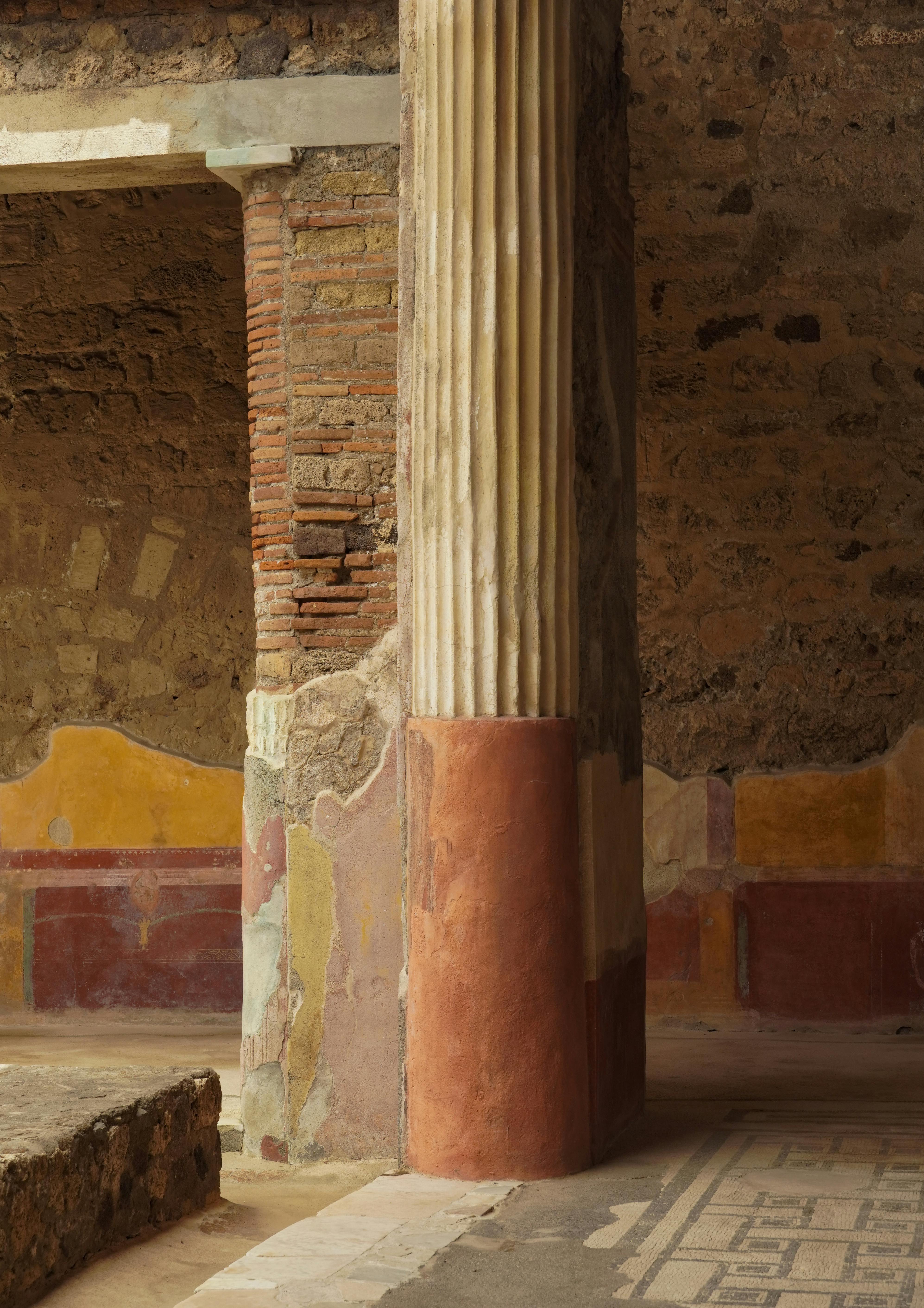 Explore the intricate details of ancient Roman architecture with vivid frescoes in Pompeii, Italy.