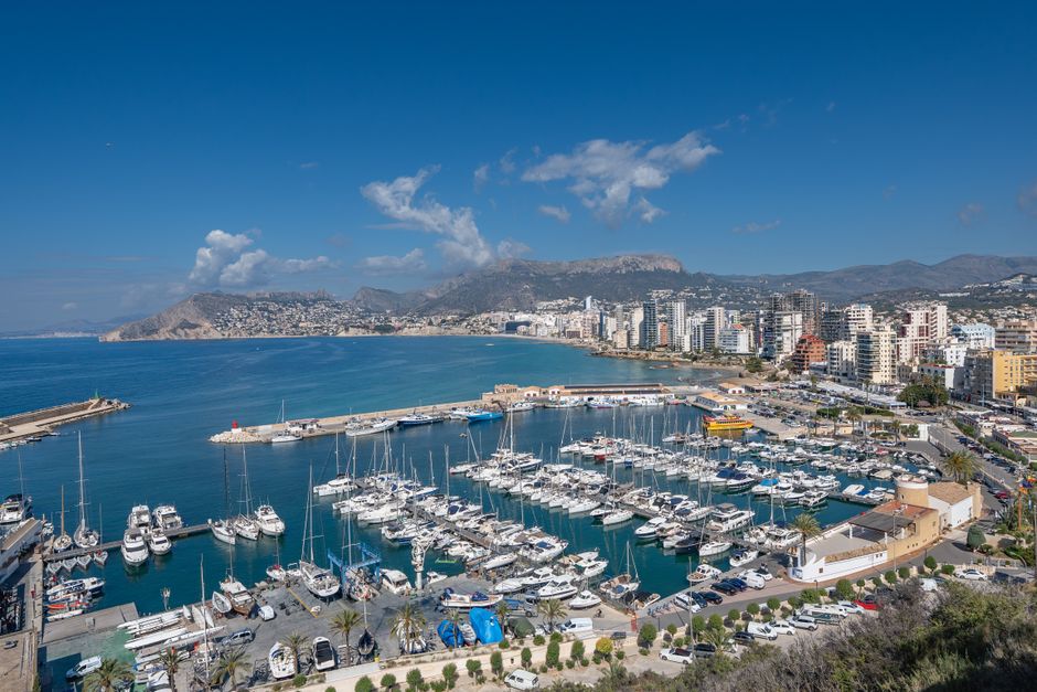 Unforgettable Private Day & Sunset Sailing Experience Drinks Snacks up 12 Guest Review: Barcelona's Ultimate Coastal Escape Review 2026 - Scenic view of Calpe, Spain, showcasing a bustling marina with yachts and the city skyline.