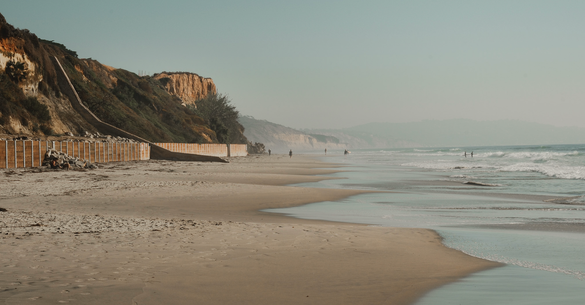 Peaceful California beach scene with stunning cliffs and tranquil ocean waves.