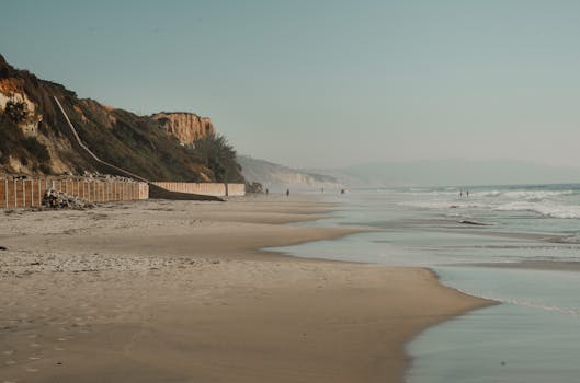 Peaceful California beach scene with stunning cliffs and tranquil ocean waves.