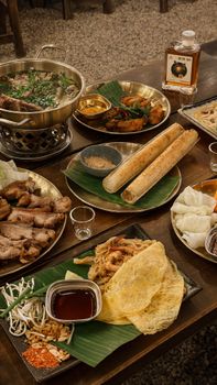 Delicious variety of traditional Vietnamese dishes served on a wooden table, capturing an authentic meal experience.