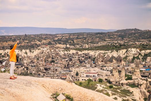 Explore the stunning rock formations of Cappadocia, Turkey captured from a scenic viewpoint with a solo traveler.