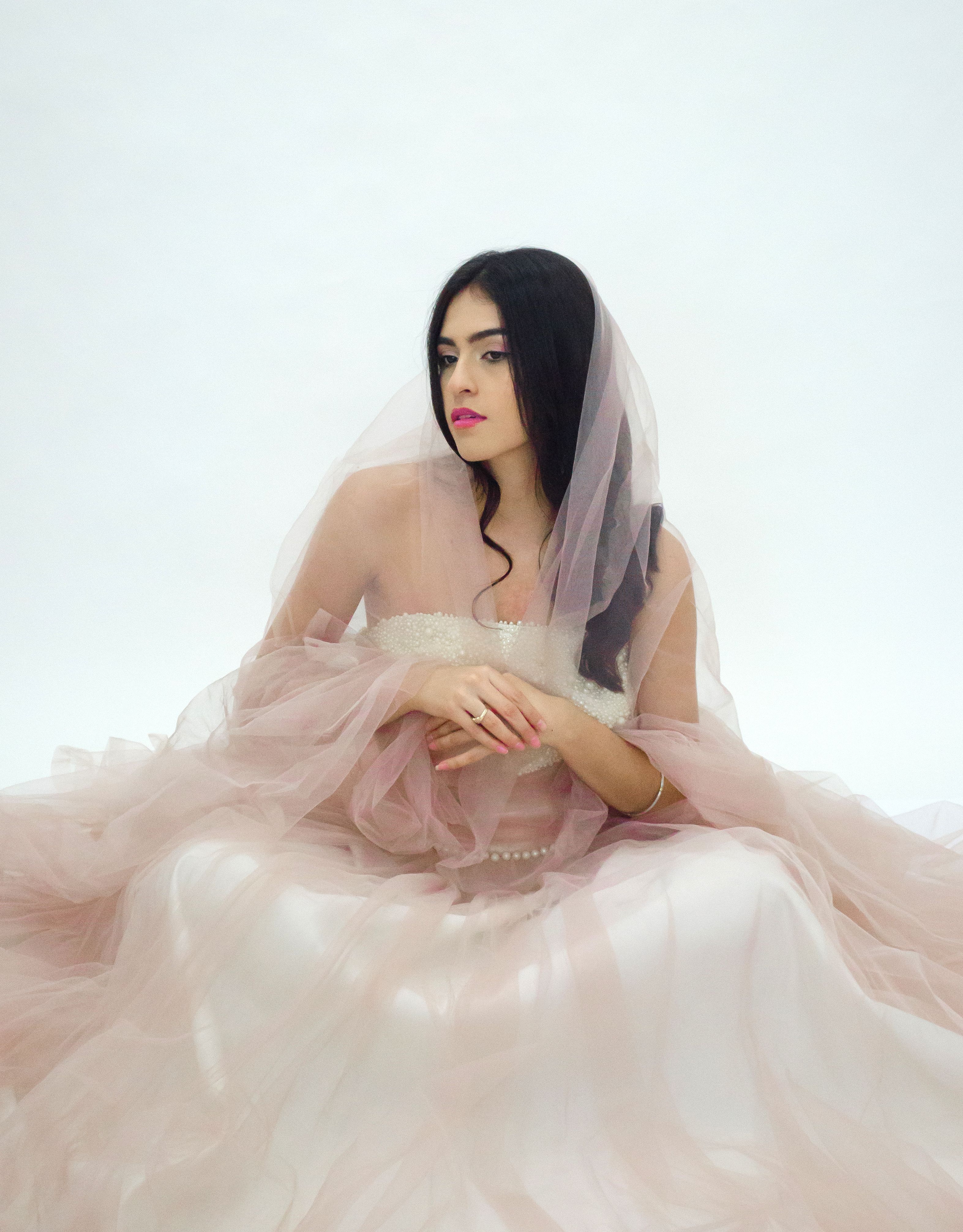 Elegant Portrait of a Woman in Soft Pink Dress · Free Stock Photo
