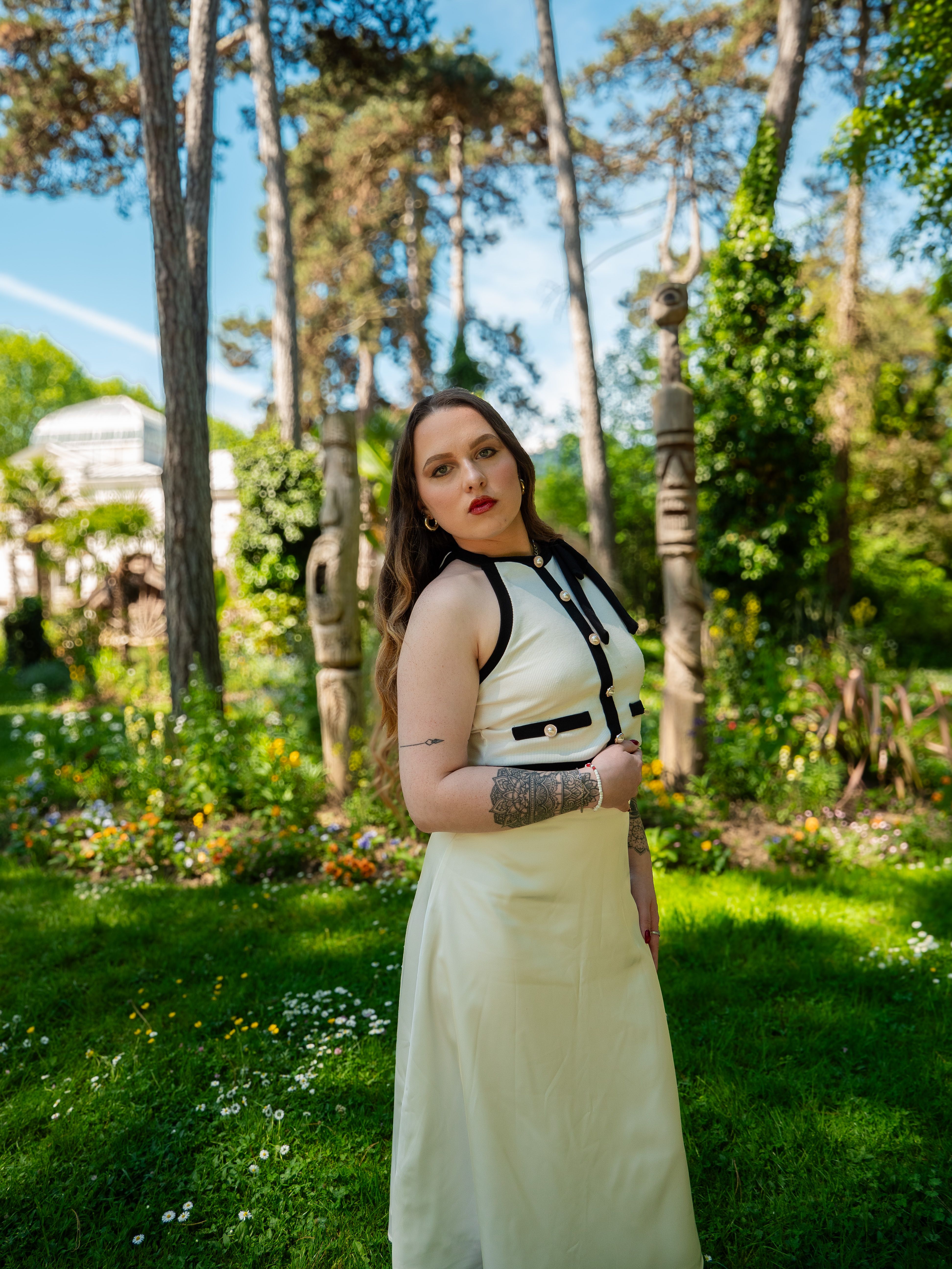 Elegant Woman Posing in Lush Park Setting · Free Stock Photo