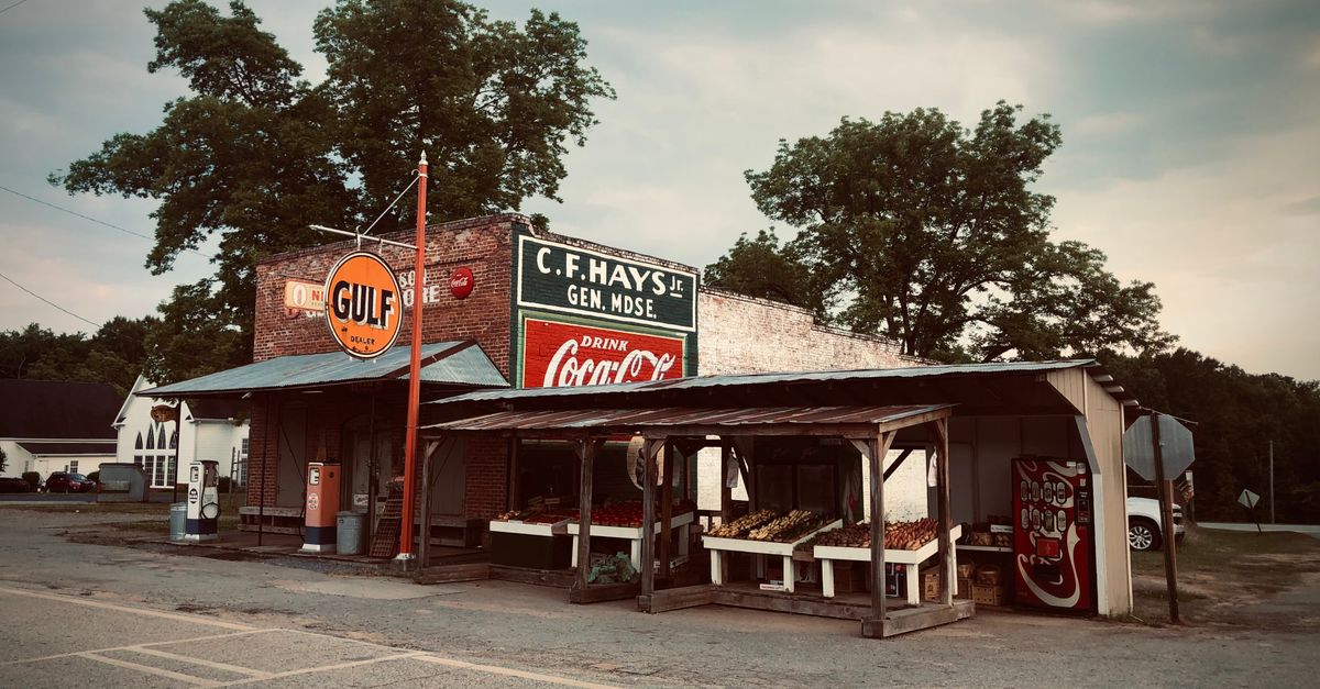 Charming small-town Georgia storefront with vintage signs and rustic appeal.