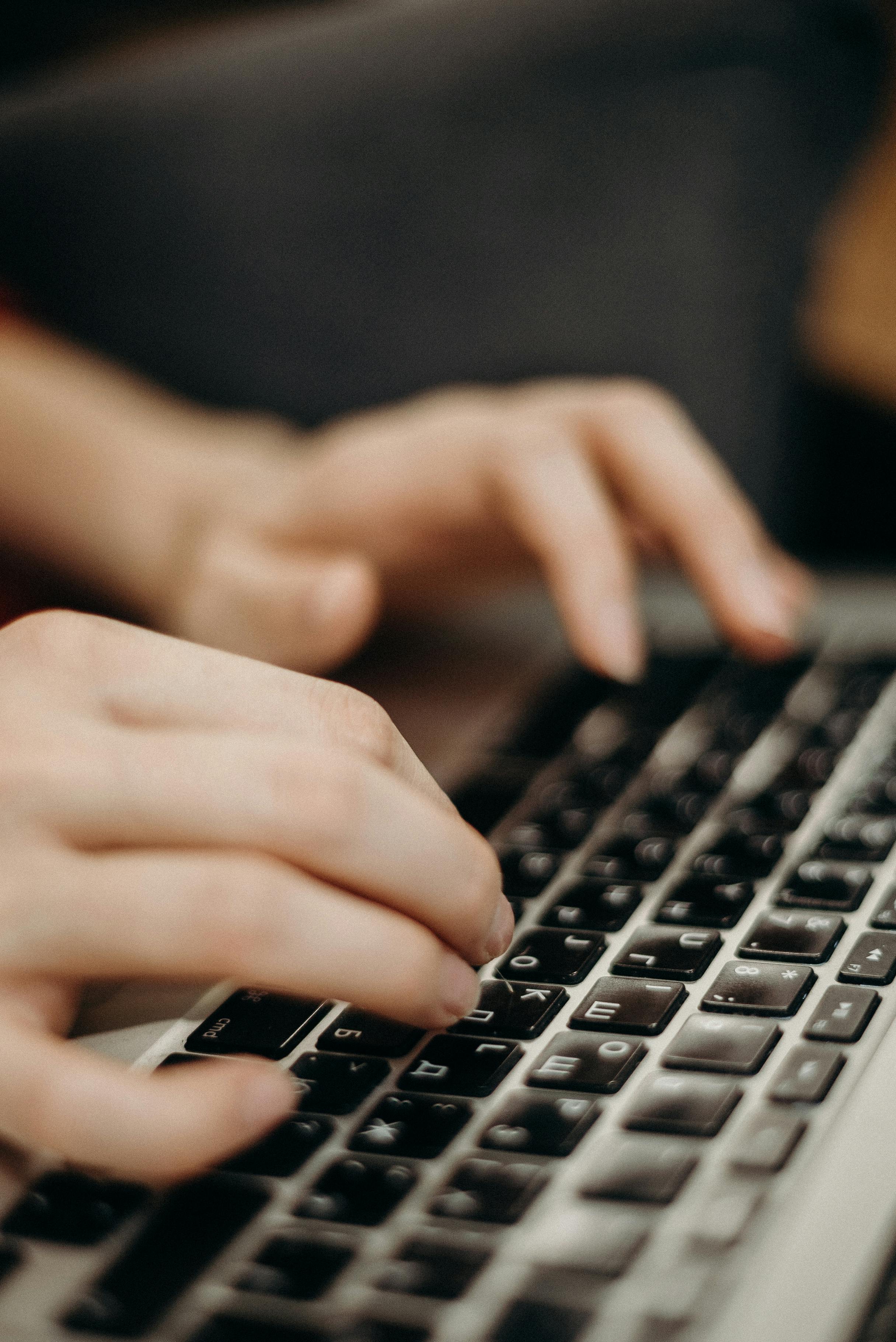 man typing on keyboard