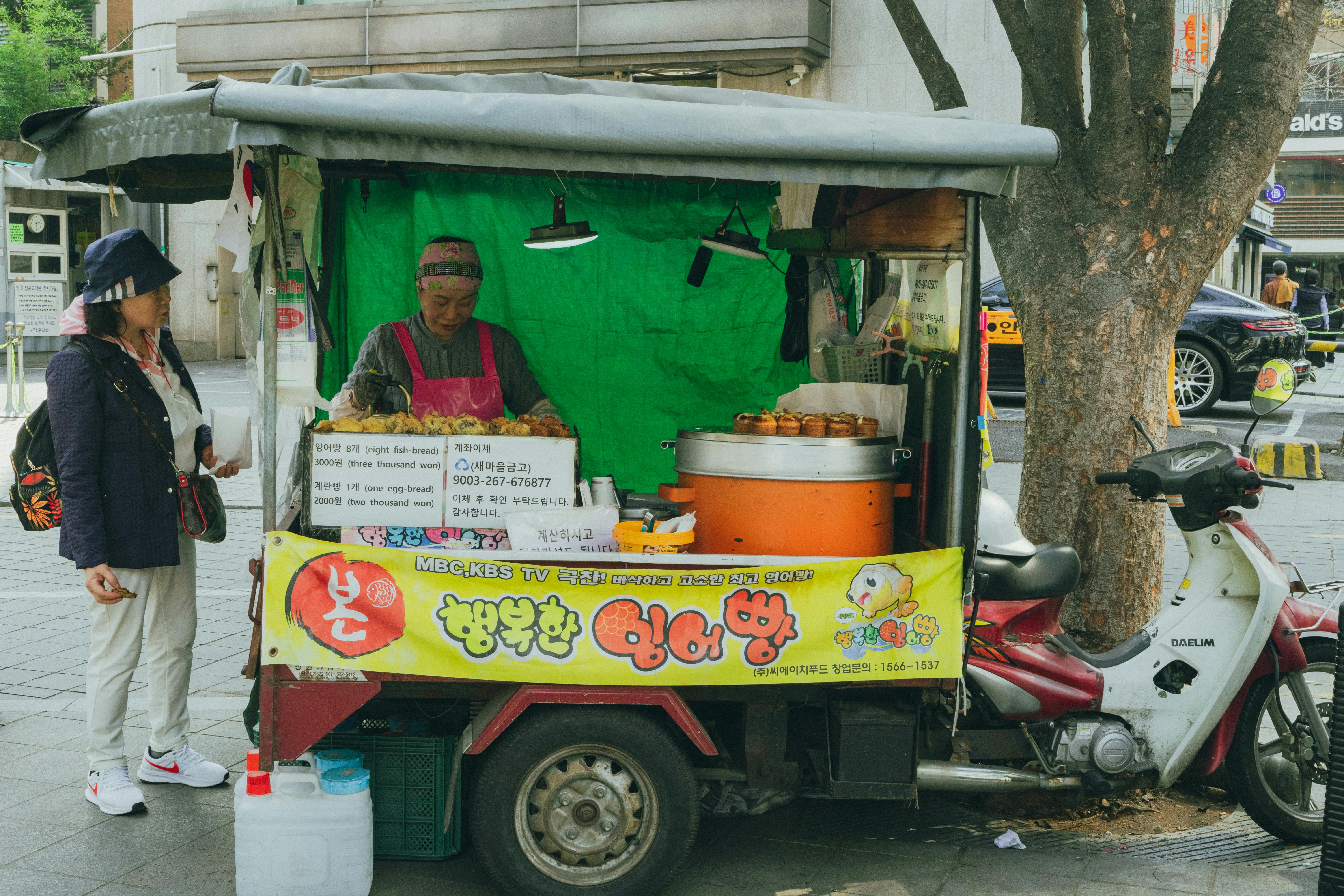 Authentic Korean street food stand in Seoul, serving traditional fish-shaped bread snacks.