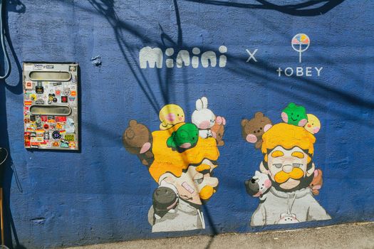 Vibrant street art featuring playful characters on a wall in Seoul, South Korea.