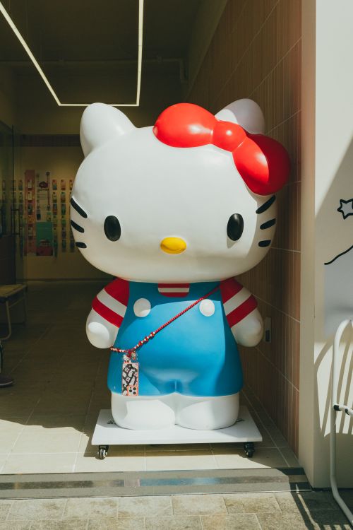 Free Large Hello Kitty statue on display in a Seoul shopping mall with bright colors and playful design. Stock Photo