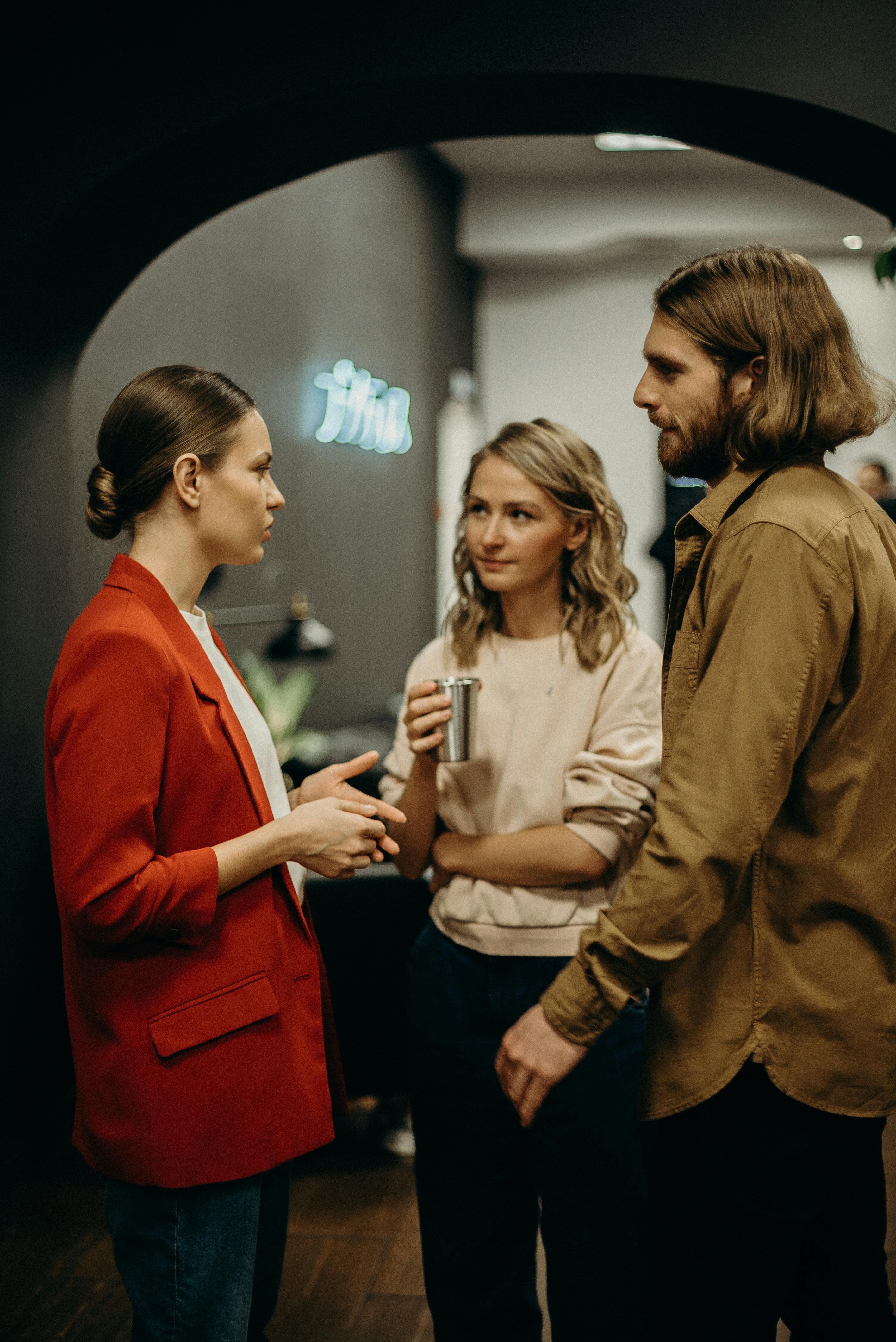 two women and man talking