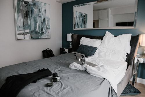 Free A cozy hotel room in Toronto with a stylish interior and workspace on the bed. Stock Photo