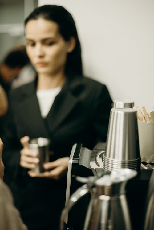 Woman Wearing Black Suit Holding A Stainless Cup