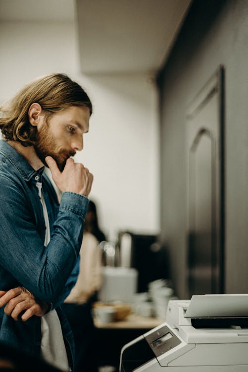 Free Man Using A Printer Stock Photo