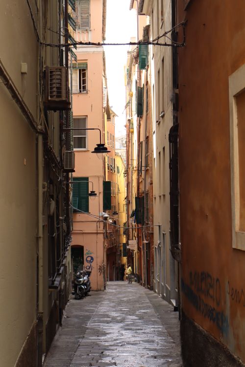 Free Explore a quaint Italian alleyway lined with colorful historic buildings. Perfect for capturing architectural beauty. Stock Photo
