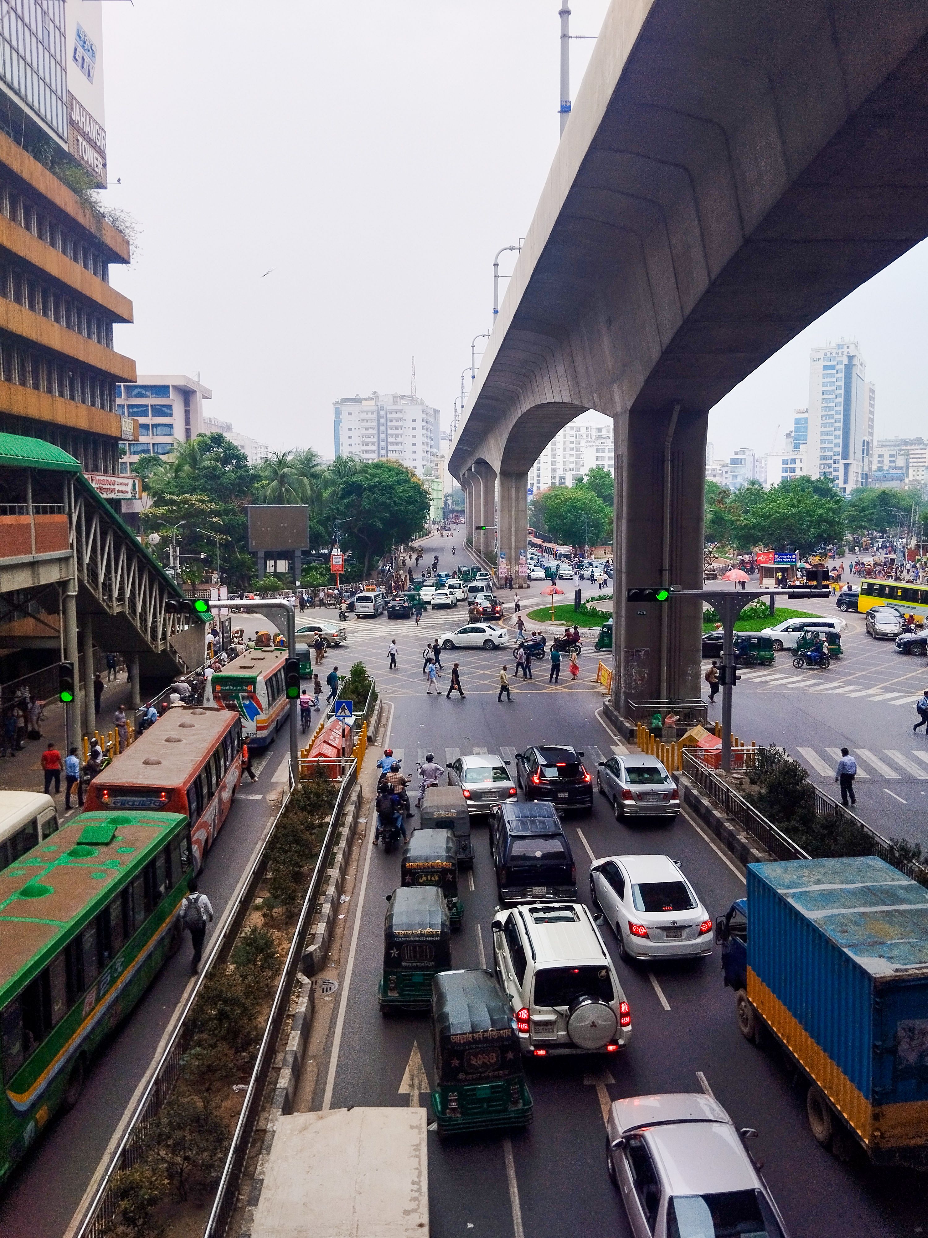 An aerial view of a bustling intersection in Dhaka, Bangladesh, showcasing city life and transportation.