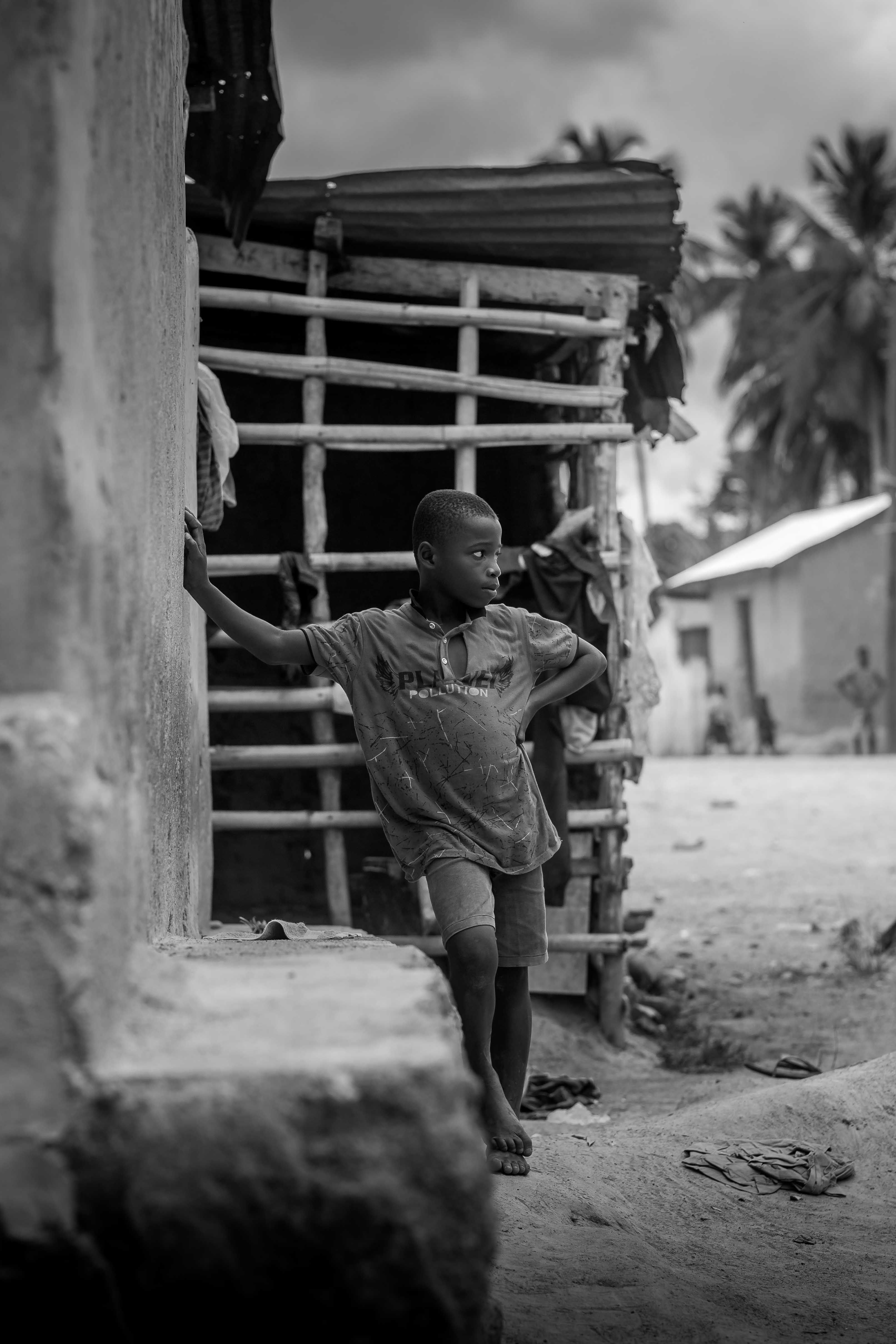 Thoughtful Child in Rustic Black and White Scene · Free Stock Photo