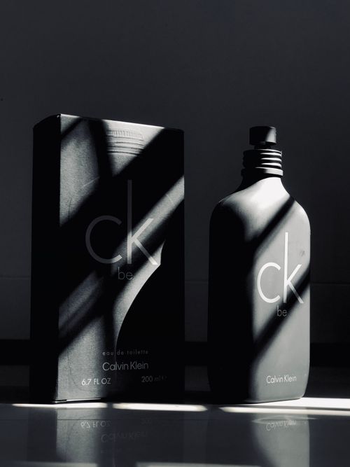 Free Calvin Klein CK Be perfume in artistic lighting with shadows. Stock Photo