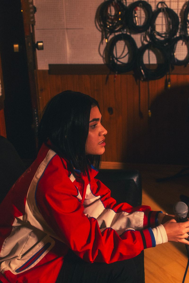 Musician holding a microphone in a professional recording studio