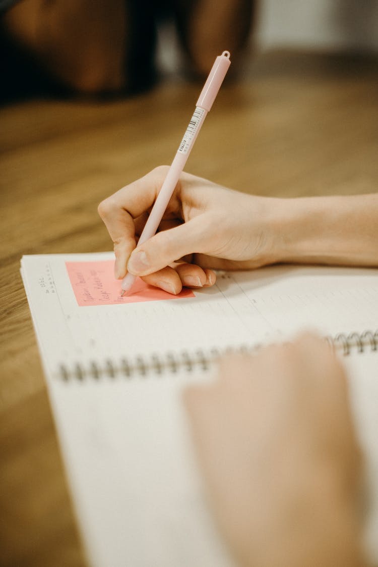 Person Holding A Pen