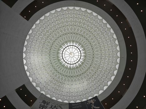 Intricate geometric dome ceiling design in a modern architectural building interior