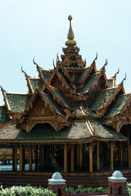 Free Detailed view of a traditional Thai temple featuring layered roofs and ornate carvings. Stock Photo