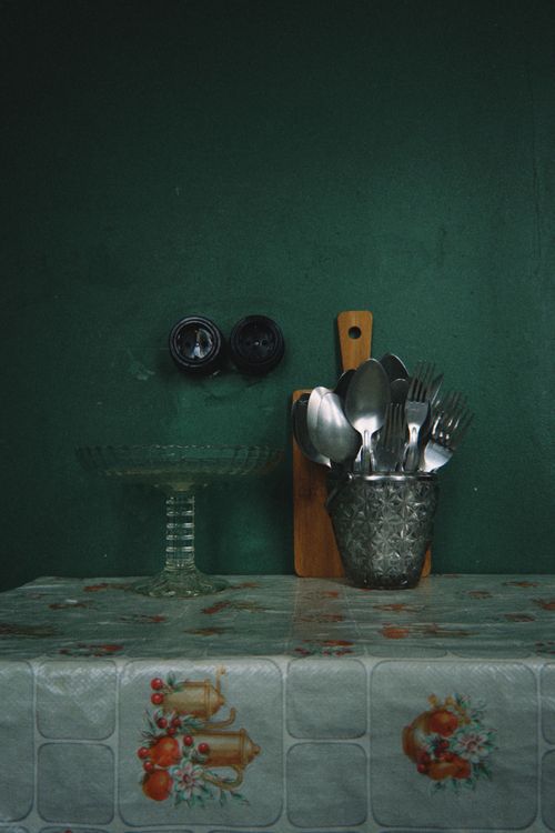 Free Aesthetic arrangement of kitchen utensils on a patterned tablecloth with vintage vibes. Stock Photo