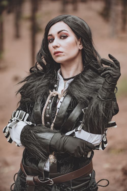 Free A woman in detailed cosplay costume poses confidently in a forest. Stock Photo