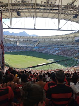 A vibrant soccer match at Maracanã Stadium with enthusiastic fans and scenic views.