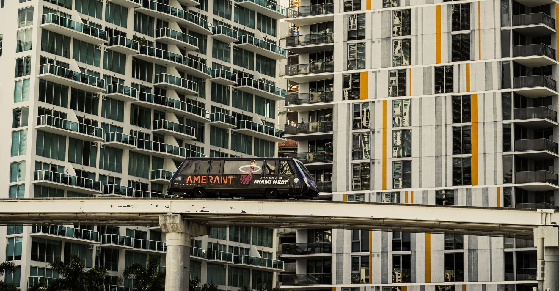 A Miami monorail travels past modern high-rise apartments in downtown Miami, Florida. — Amanda Anisimova in Florida