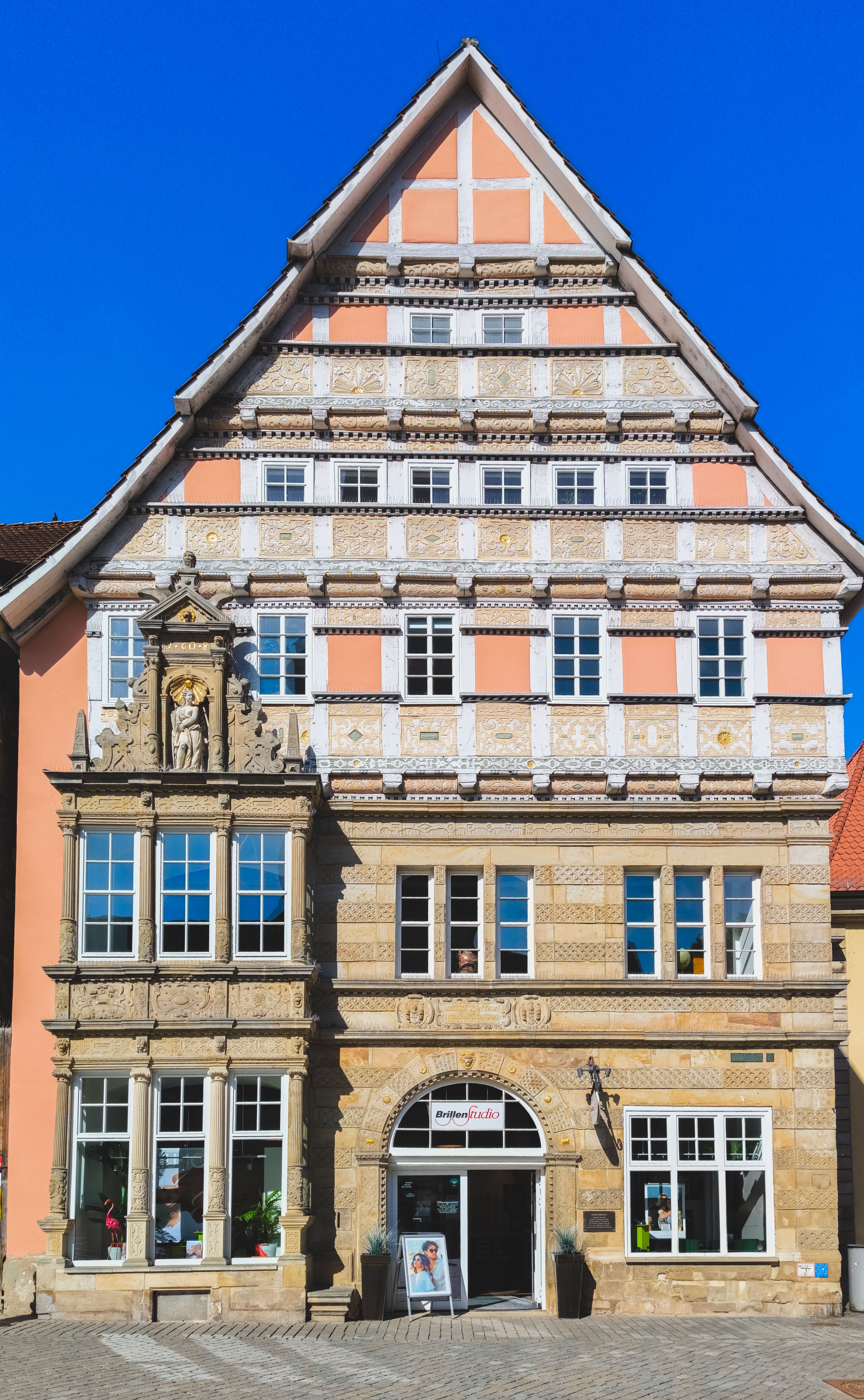 A beautifully preserved historic building in Germany, showcasing intricate architectural details under clear blue skies.