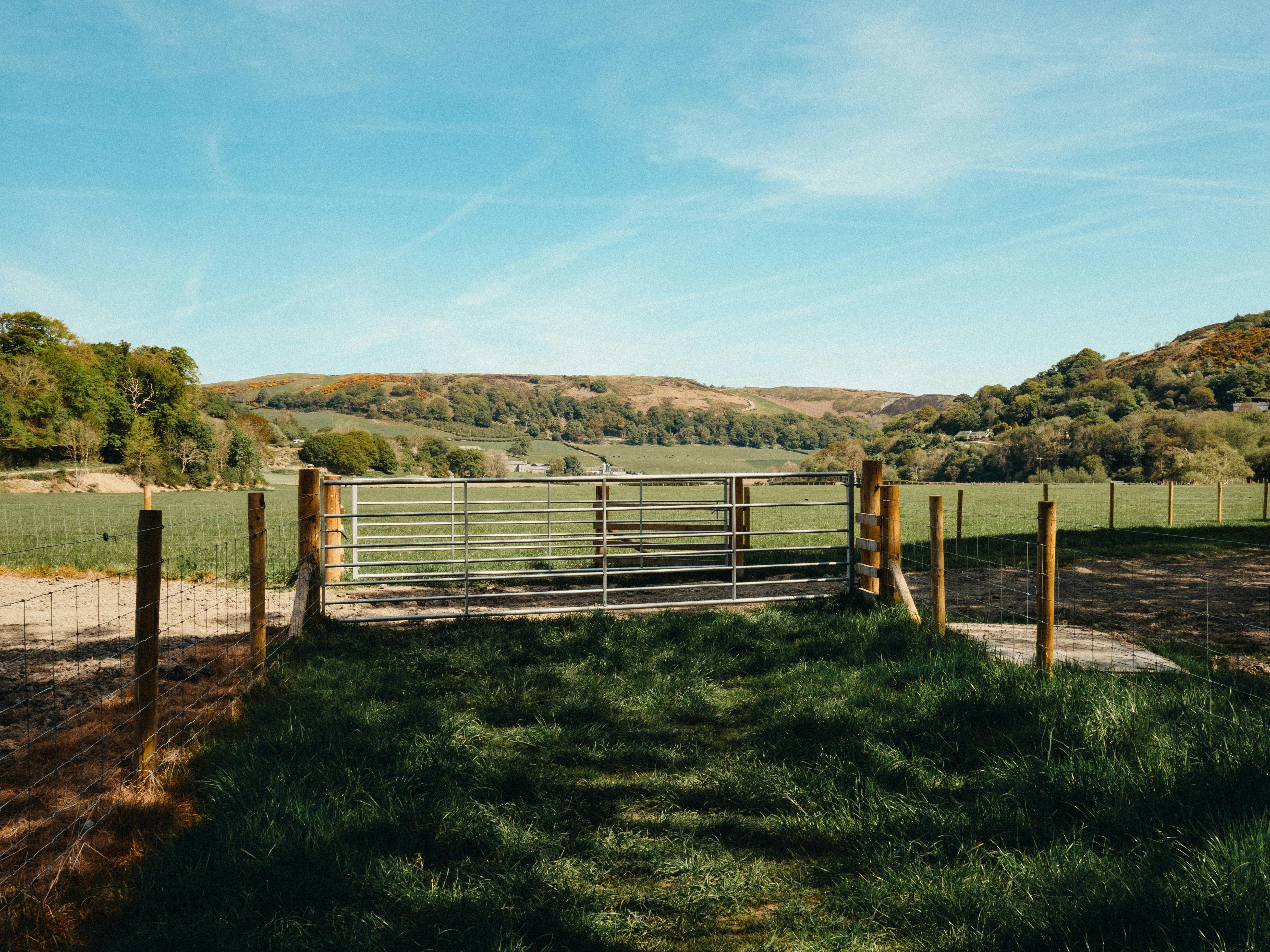 Beautiful rural scene with gate and hills in Llanfair Talhaiarn, Wales.