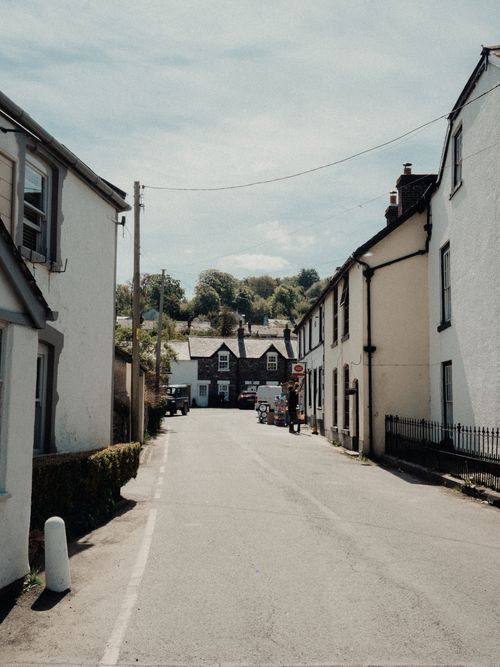 Free Charming village street view in Llanfair Talhaiarn, Wales with scenic countryside backdrop. Stock Photo