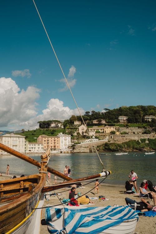 Free Beautiful day at Sestri Levante beach with sailboat and people enjoying the sun. Stock Photo