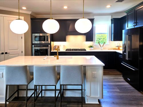 Free Sleek kitchen design featuring an island, pendant lights, and contemporary appliances. Stock Photo