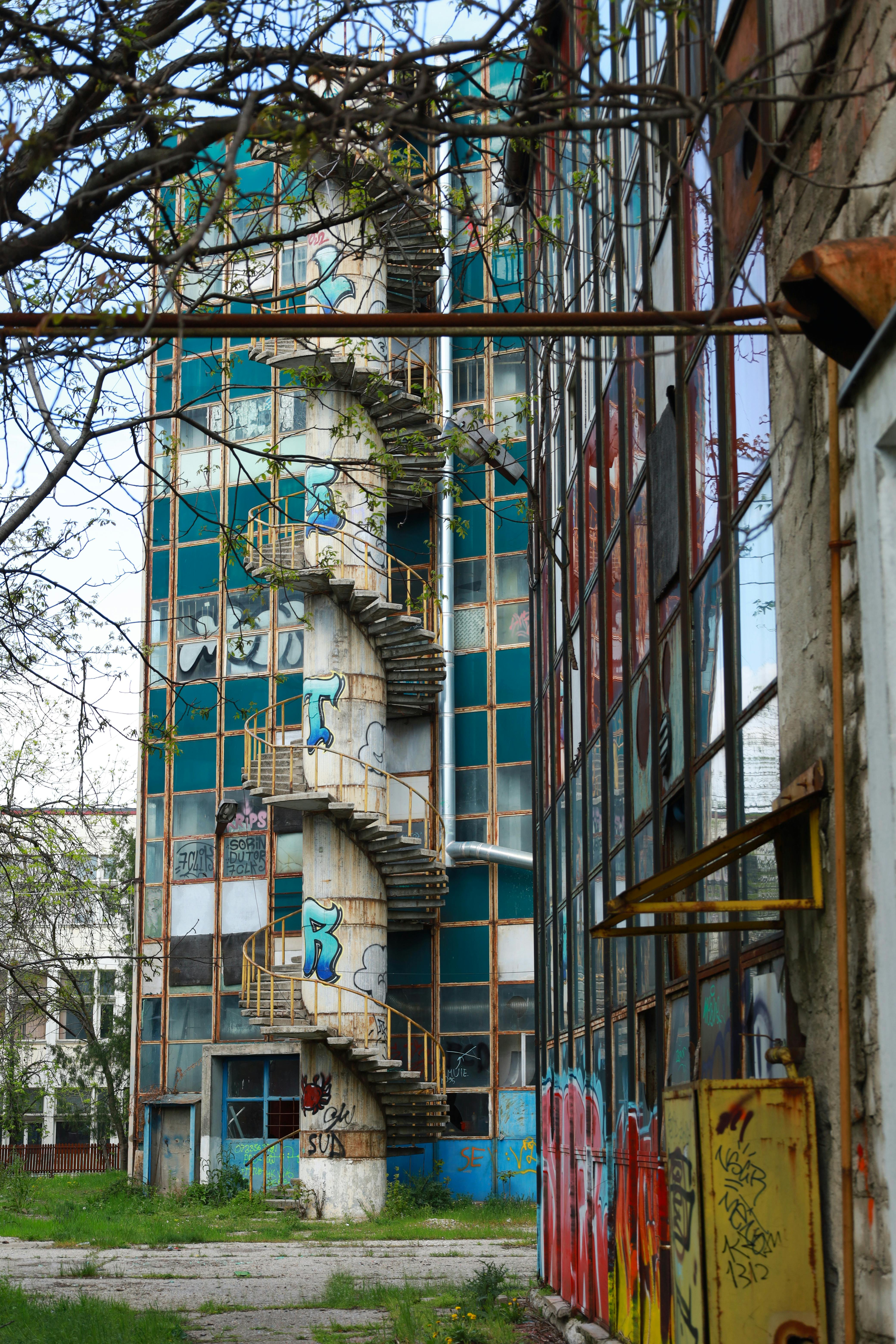 Explore the decay of an industrial building with a spiral staircase.