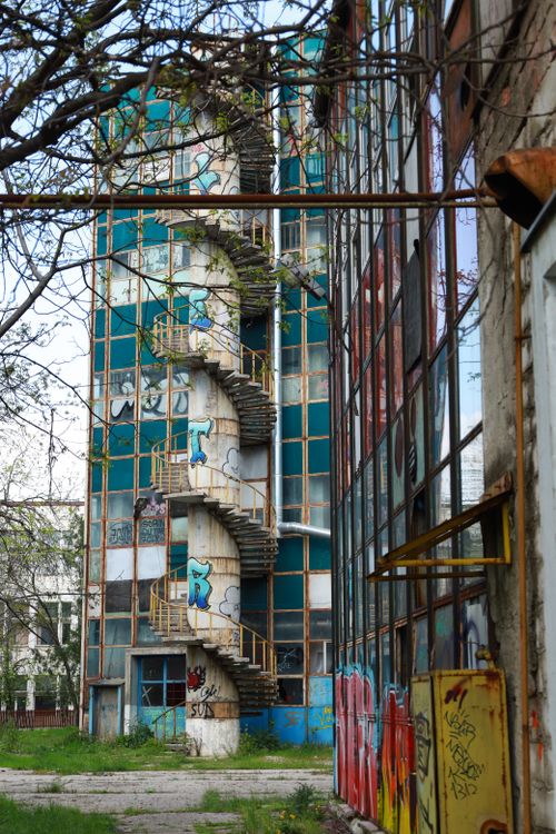 Free Explore the decay of an industrial building with a spiral staircase. Stock Photo