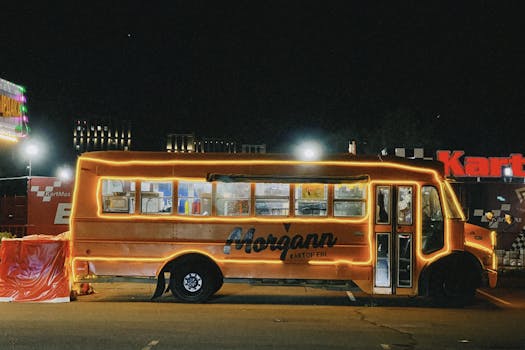 A brightly lit food truck at night in Astana, offering a unique street food experience.
