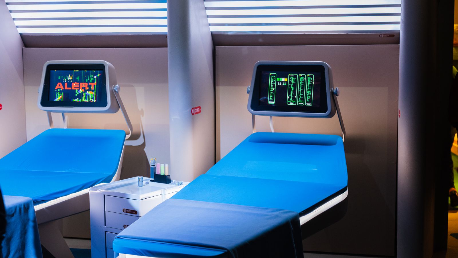 A modern hospital room featuring advanced medical equipment with digital displays.