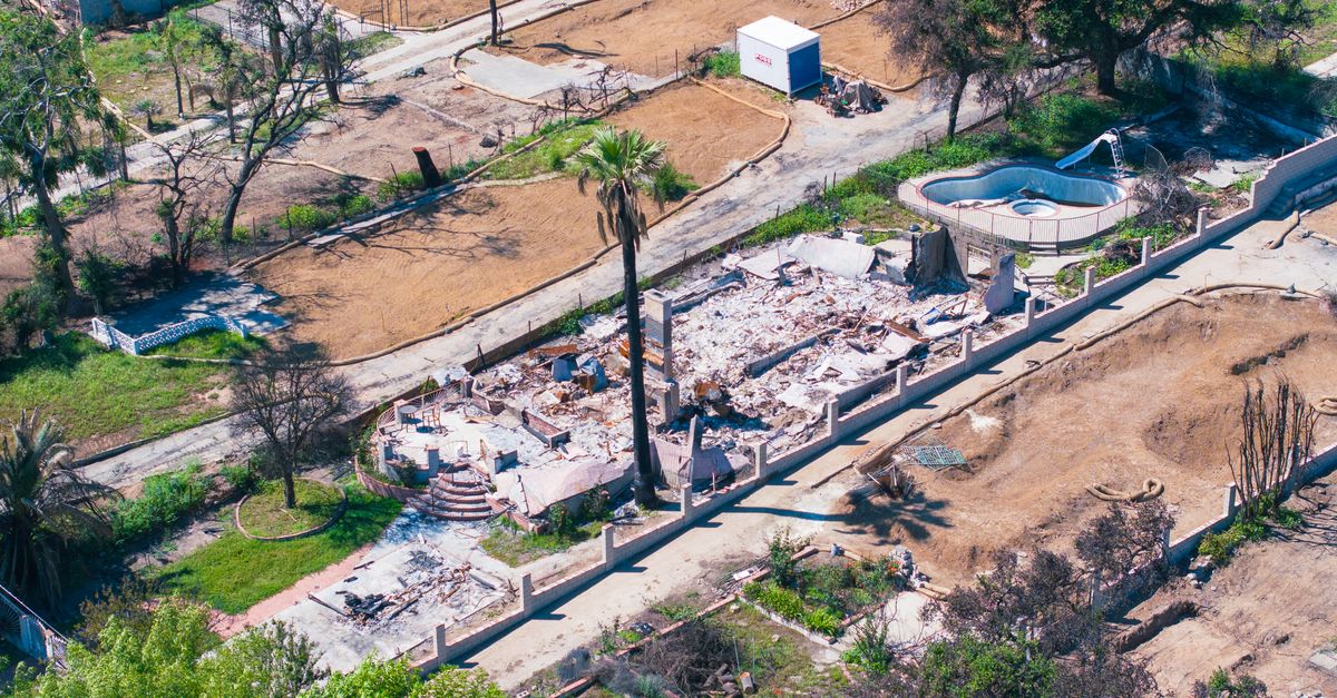 Aerial shot showing a destroyed house by wildfire in Altadena, California, highlighting the devastation.