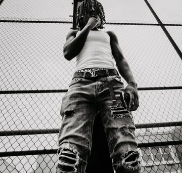 Stylish young adult in a New York playground, showcasing urban fashion.
