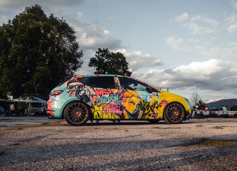 A colorful custom car with graffiti art design at a car meet in Sarajevo, Bosnia and Herzegovina.