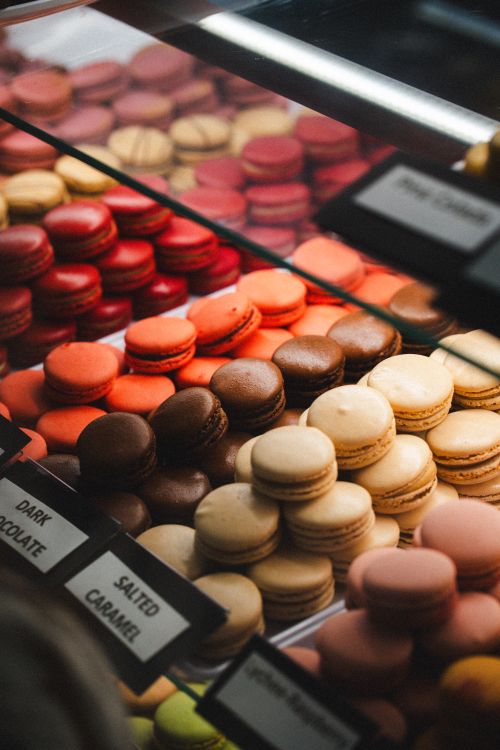 Free Colorful French macarons in a bakery display case. A delightful variety of flavors and colors. Stock Photo