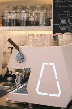 Contemporary coffee shop interior featuring a sleek espresso machine and minimalist decor.