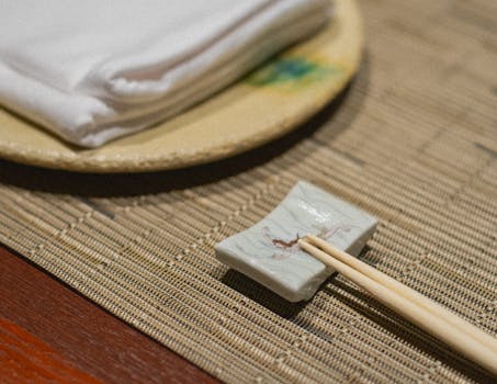 A sophisticated Japanese dining setup featuring chopsticks and cloth napkins in Kamogawa, Japan.