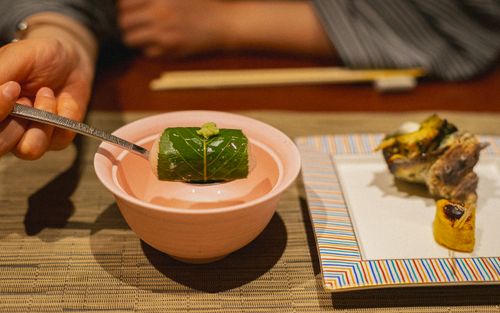 Free A dish featuring wrapped fish in pickled leaf and wasabi in Kamogawa, Japan. Stock Photo