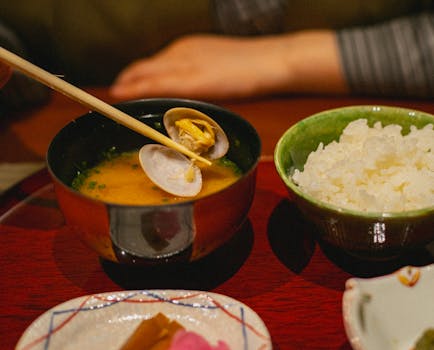 Close-up of traditional Japanese clam soup and rice, perfect for a cozy dining experience.